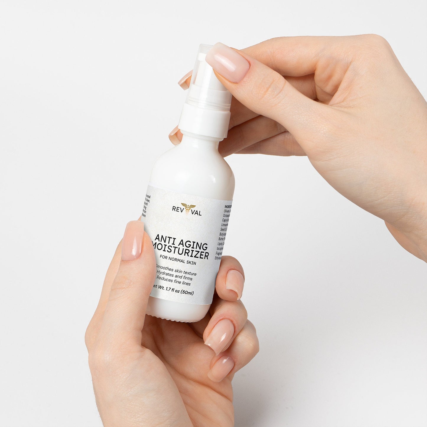 Hand holding a bottle of Reviva Labs Anti Aging Moisturizer against a light background