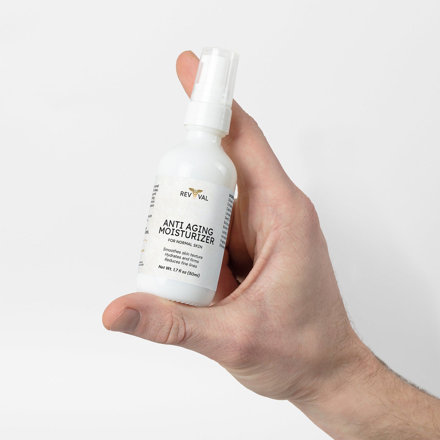 Hand holding a bottle of RevivaL Anti Aging Moisturizer against a white background