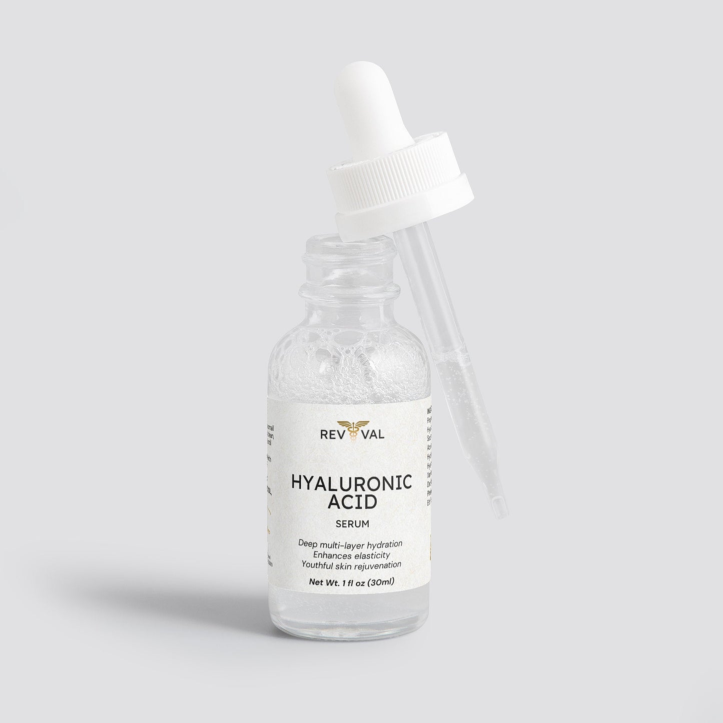 Bottle of Revival Hyaluronic Acid Serum on a light gray background