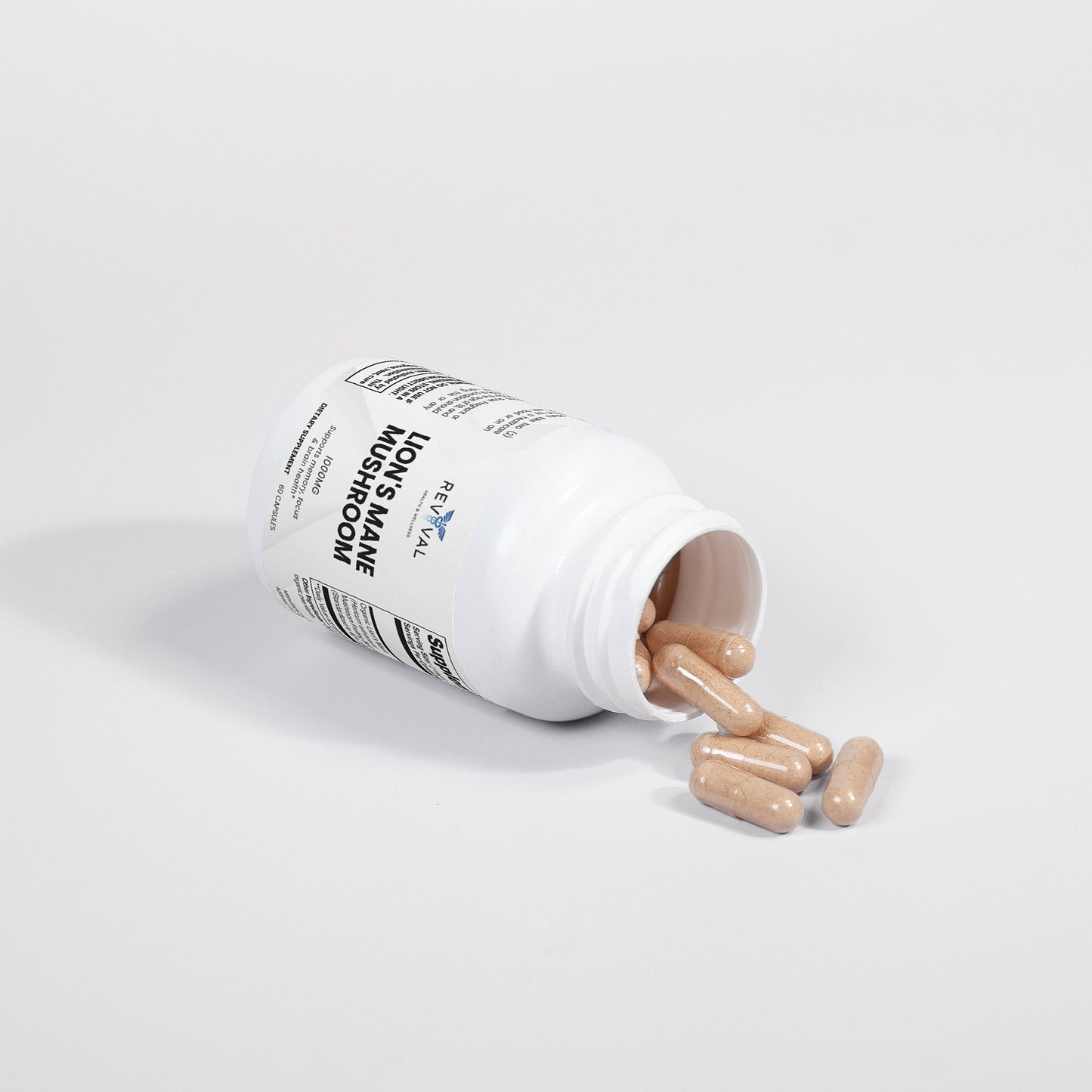 Supplement bottle with pills spilling out on a light gray background