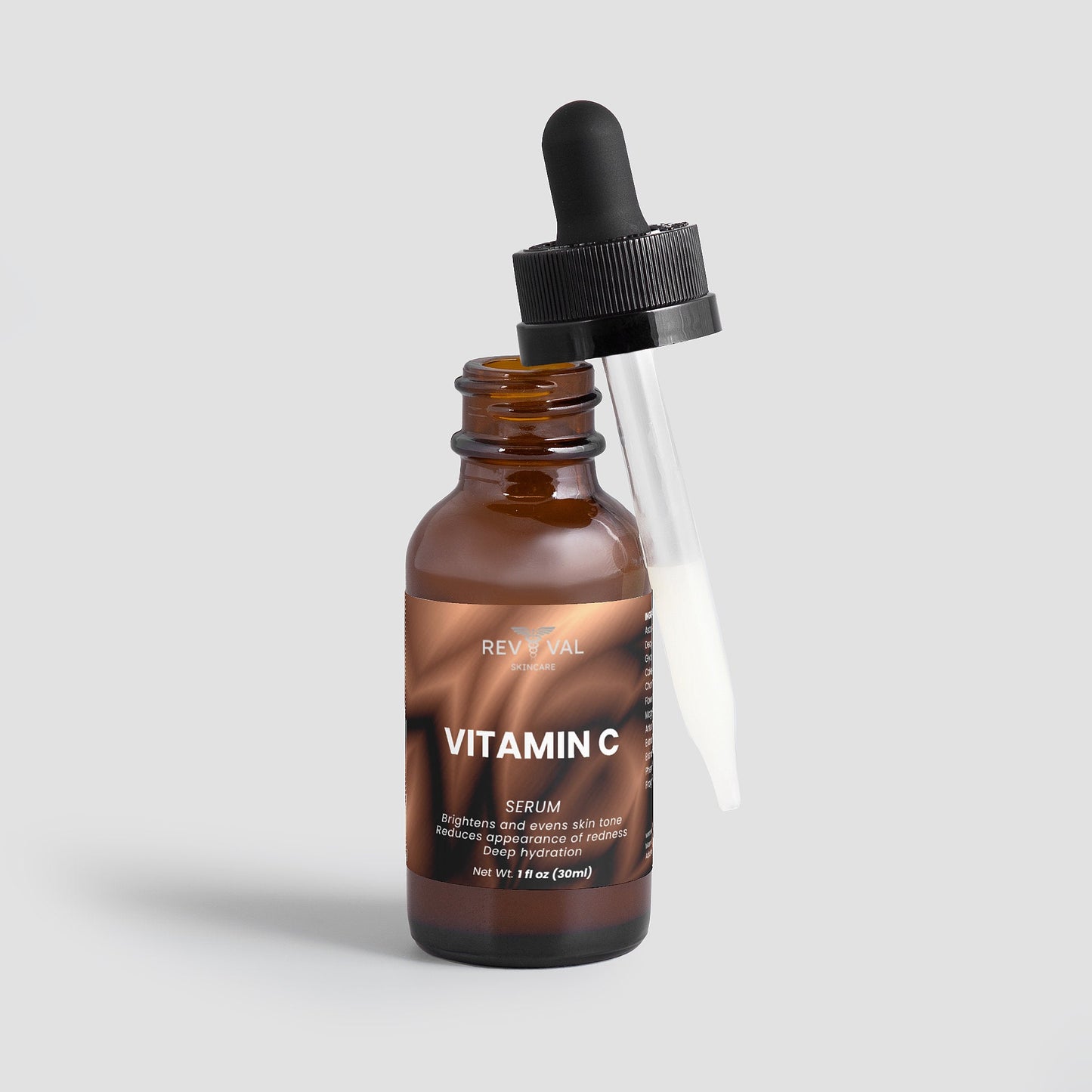 Brown glass bottle with dropper labeled 'Vitamin C Serum' on a light gray background