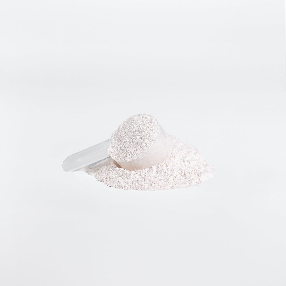 White scoop with powder on a white background