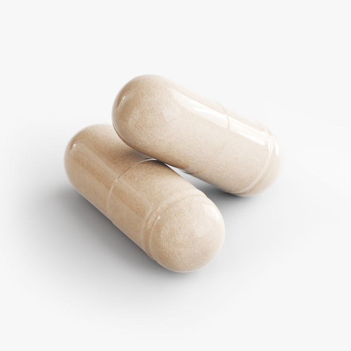 Two beige translucent capsules lying on a light gray background.