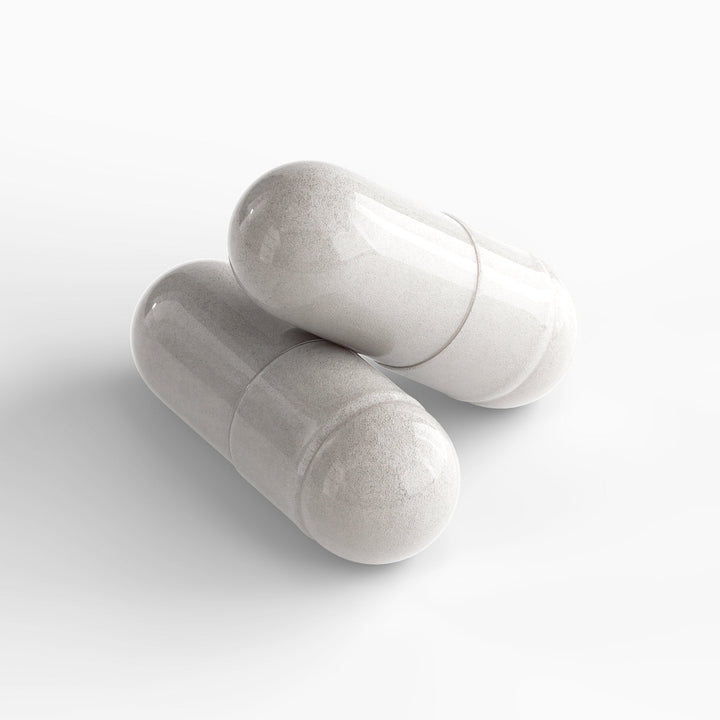 Two white marble objects on a light gray background