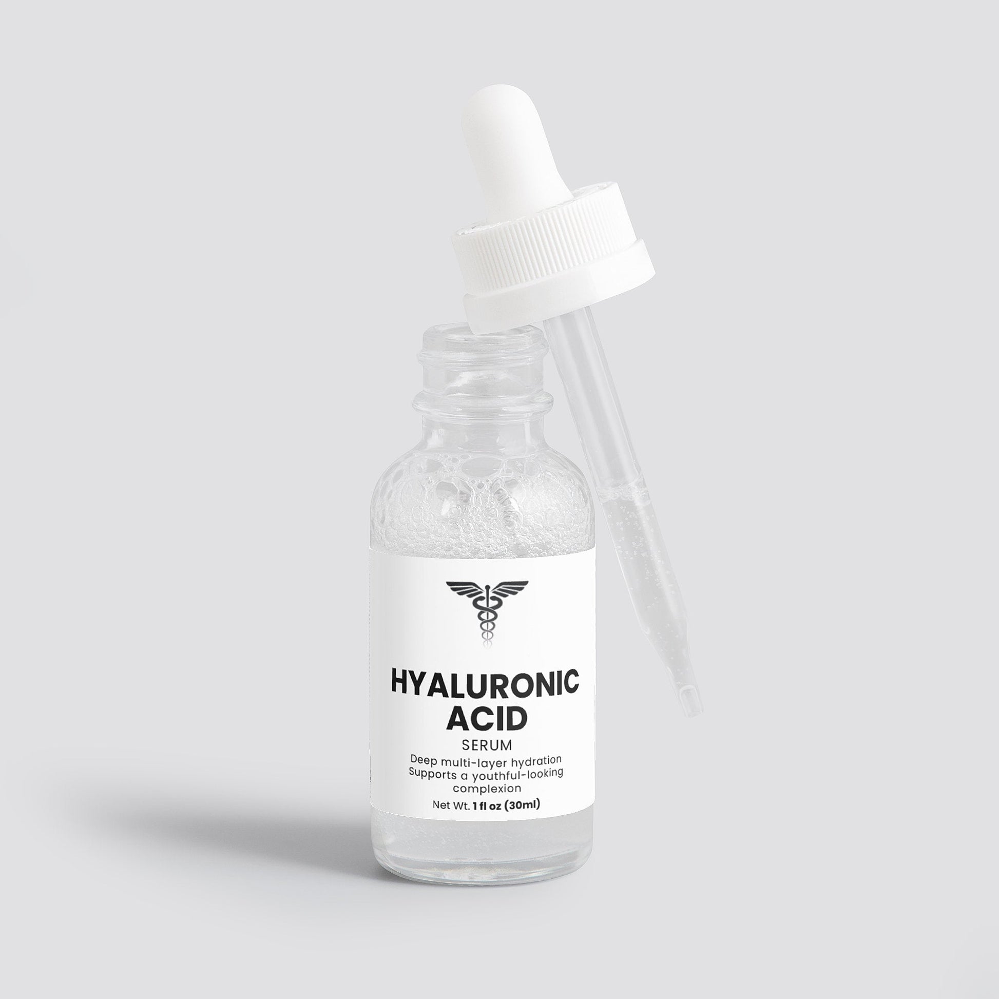 Bottle of hyaluronic acid serum with a white cap on a light gray background