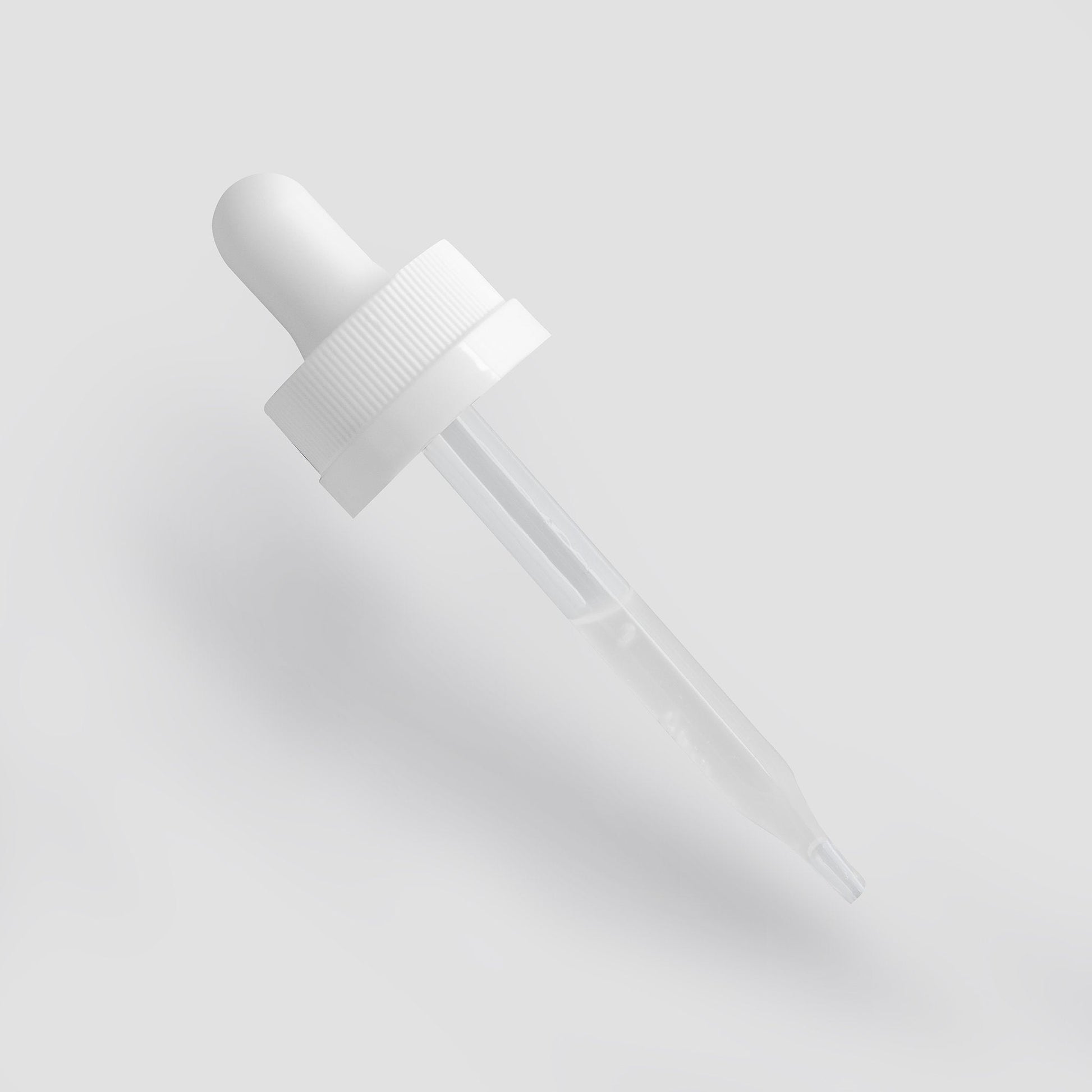 White dropper bottle on a light gray background