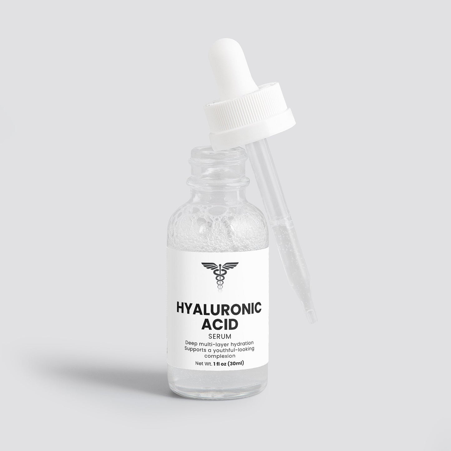 Bottle of hyaluronic acid serum with a white cap on a light gray background