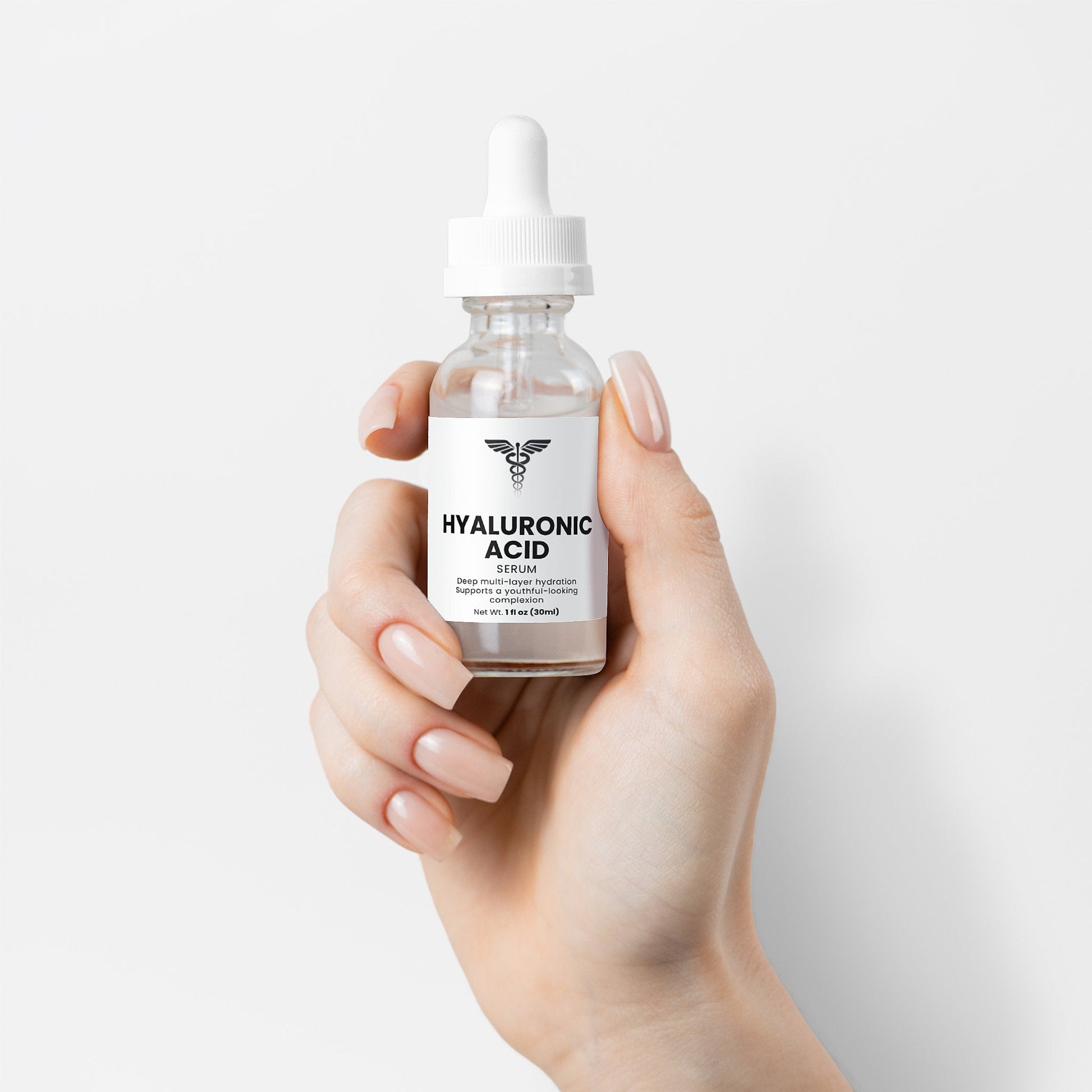 Hand holding a bottle of hyaluronic acid serum with a white background