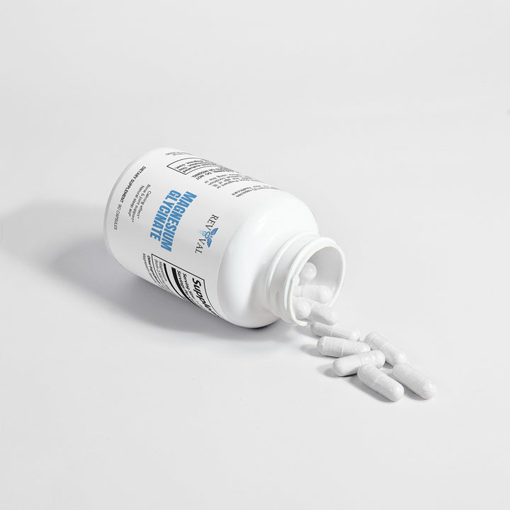 White supplement bottle with pills spilling out on a light gray background
