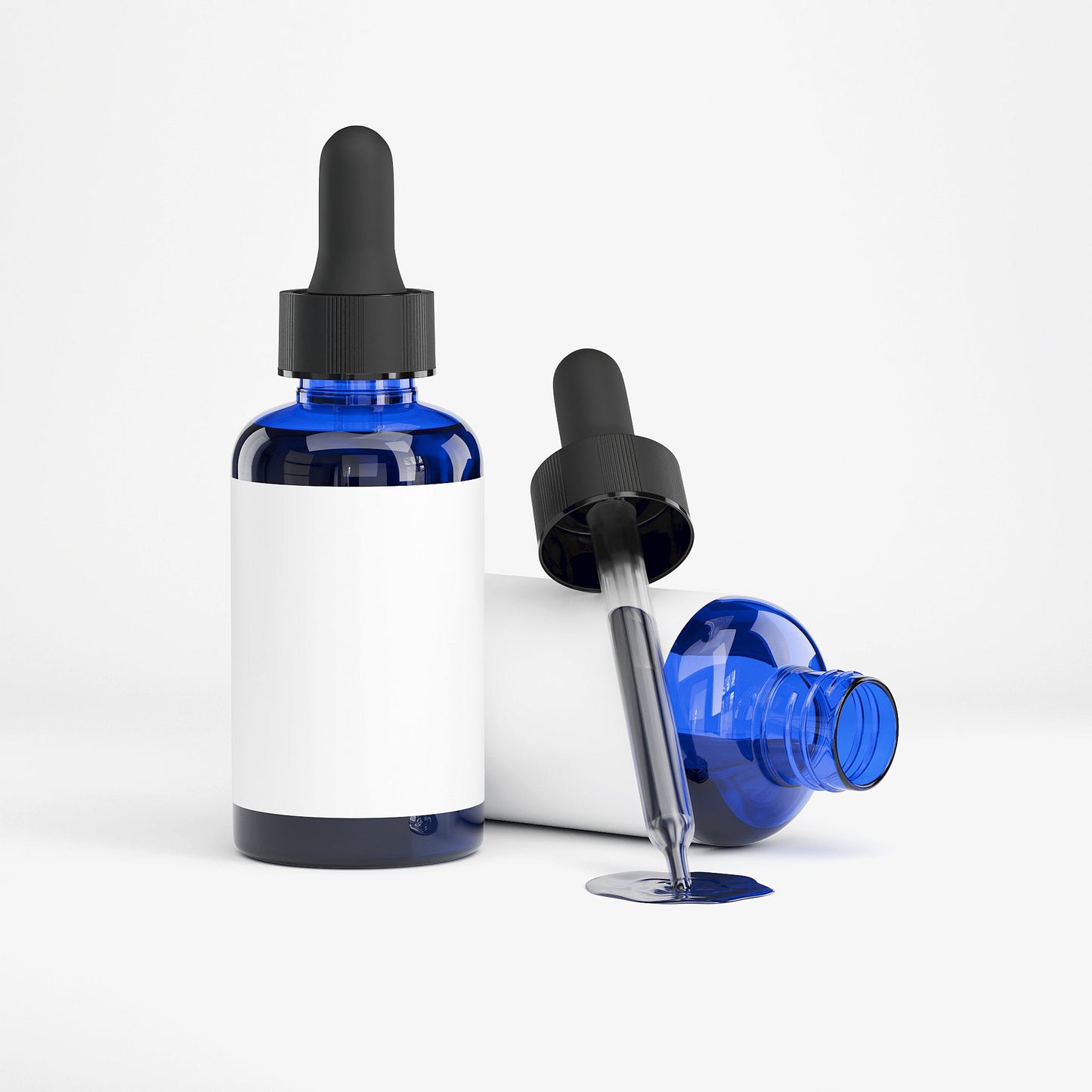 Blue glass dropper bottles with black caps on a white background