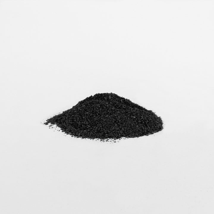 Pile of black granular material on a white background