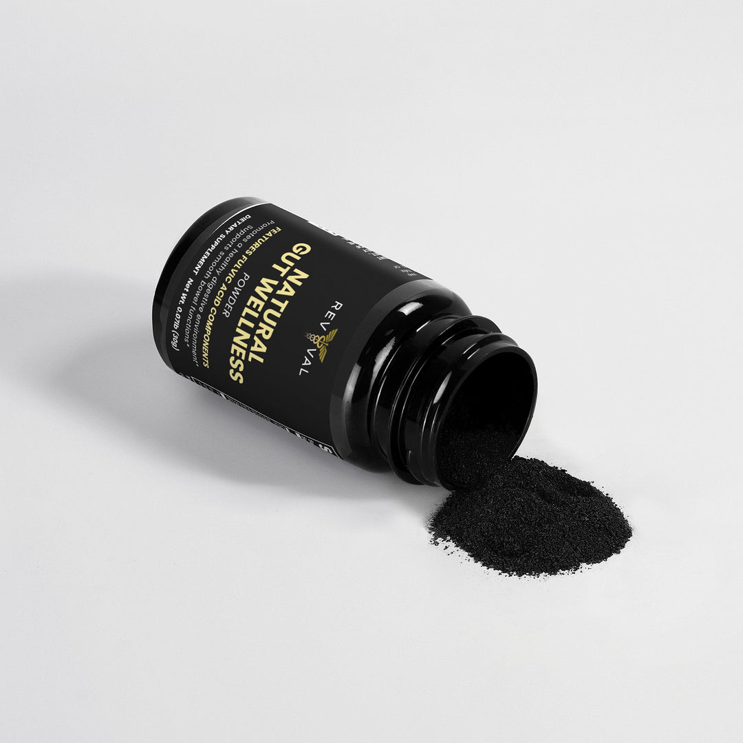 Black powder spilling out of a black bottle labeled 'NATURAL WELLNESS' on a light gray background